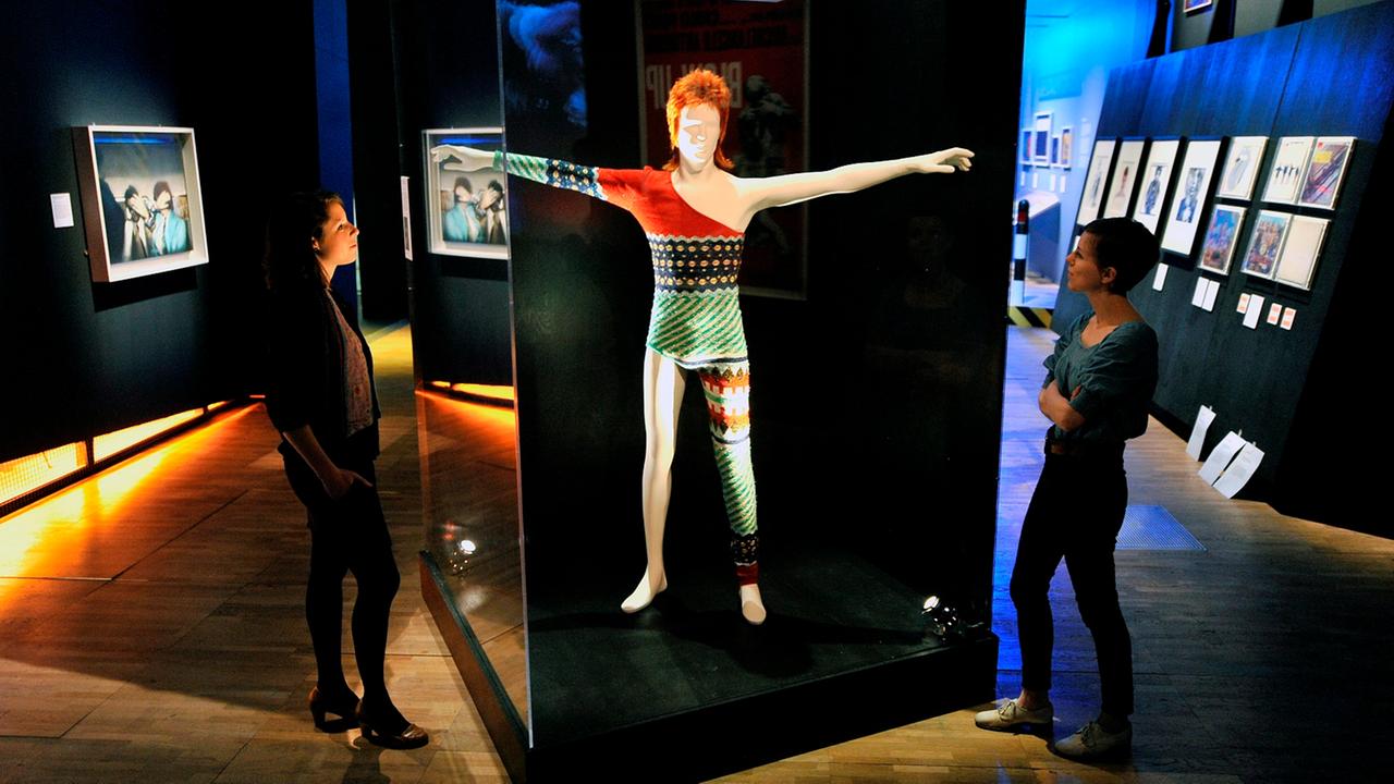 epa03161301 V&A Museum staff look over Kansai Yamamoto's 1973 stage costume for David Bowie at the Victoria and Albert (V&A) museum in London, Britain, 27 March 2012. The V&A's spring exhibition is highlighting the best in British design and creative tale epa03161301 V&A Museum staff look over Kansai Yamamoto's 1973 stage costume for David Bowie at the Victoria and Albert (V&A) museum in London, Britain, 27 March 2012. The V&A's spring exhibition is highlighting the best in British design and creative tale