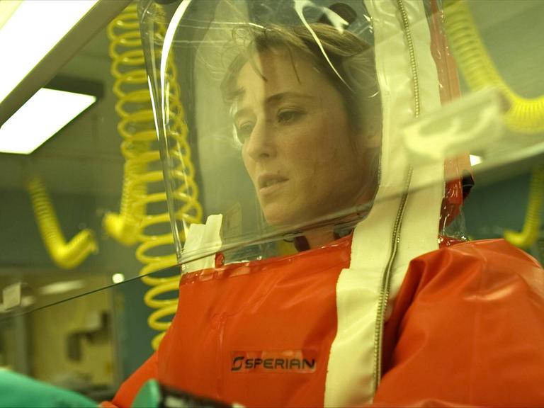 Schauspielerin Jennifer Ehle as Dr. Ally Hextall in dem Thriller "Contagion". Eine Wissenschaftlerin in Schutzkleidung im Labor.
