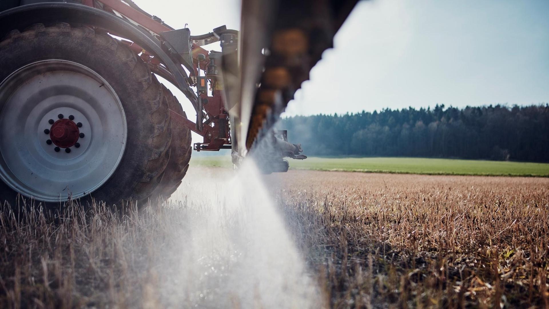  Ein Traktor fährt bei Göttingen über ein Feld und bringt mittels einer gezogenen Anhängespritze Glykosphat aus.