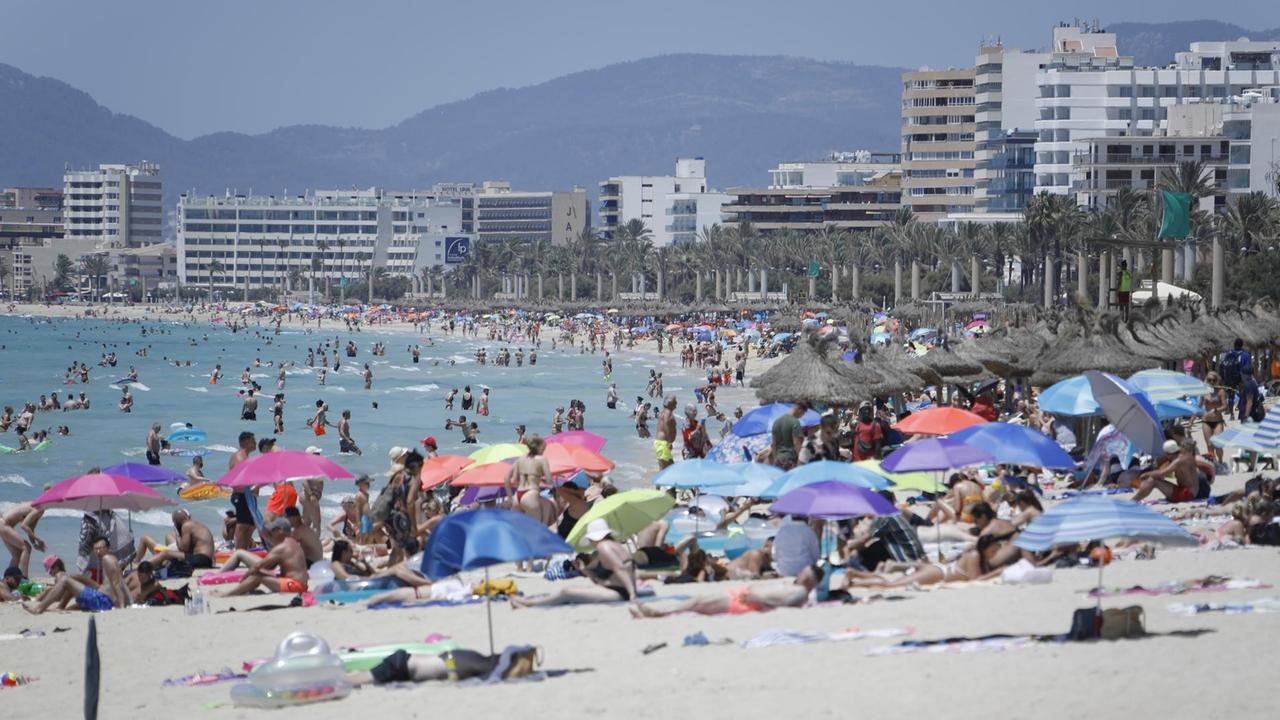 Touristen genießen am 9.7. die Sonne am Strand von Arenal, Mallorca.