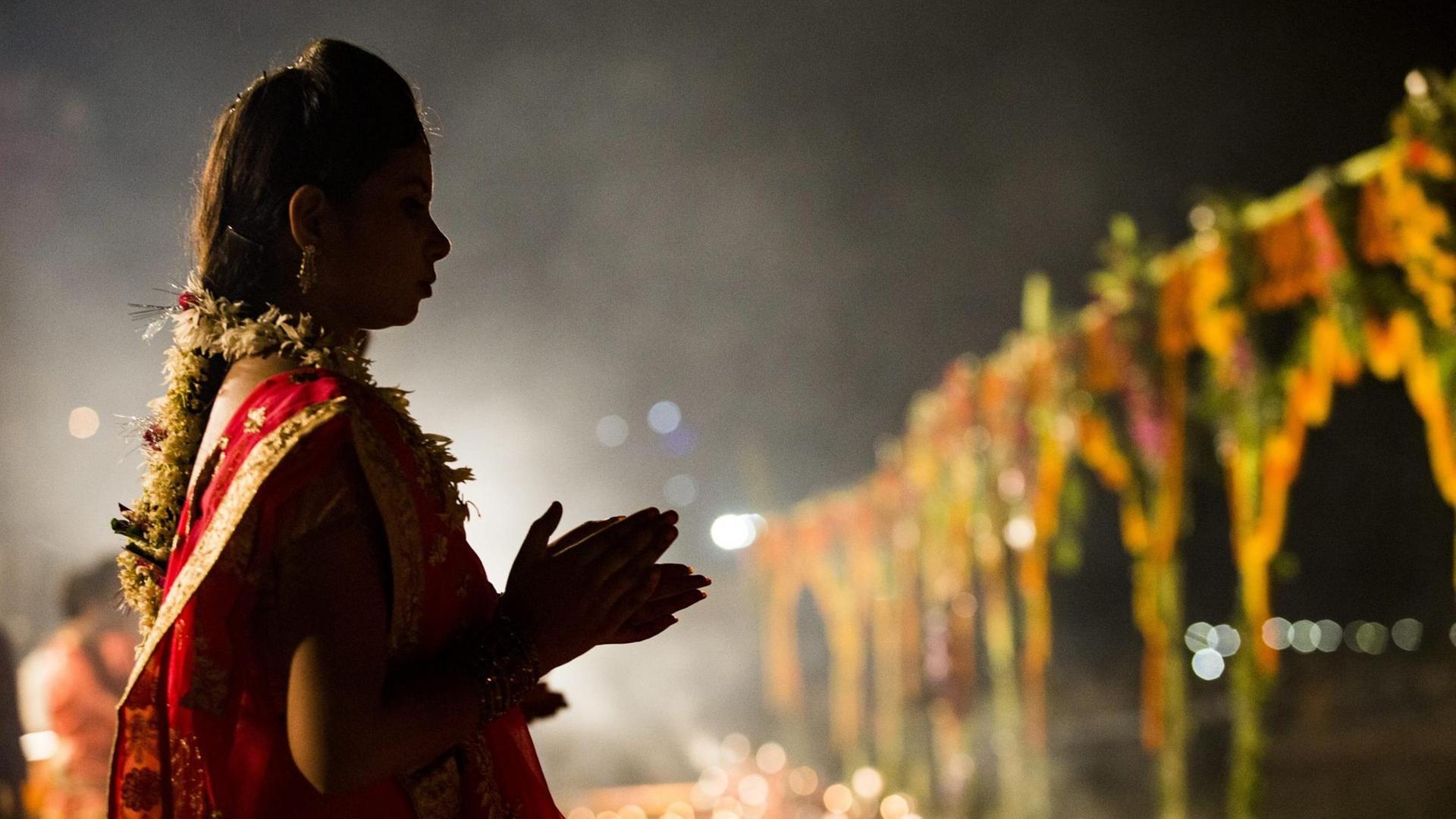 Silhouette einer Frau in einem traditionellen Hindu-Kostüm.