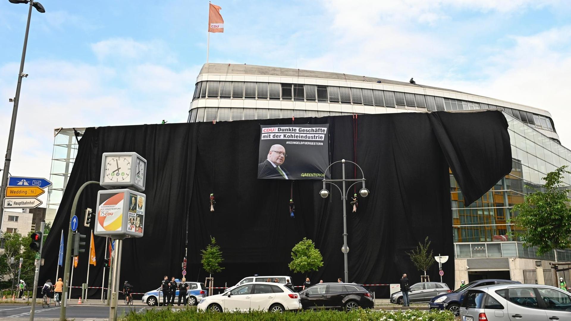 Die CDU-Zentrale ist mit schwarzen Tüchern verhängt und einem Plakat, auf dem steht: "Dunkle Geschäfte mit der Kohleindustrie".