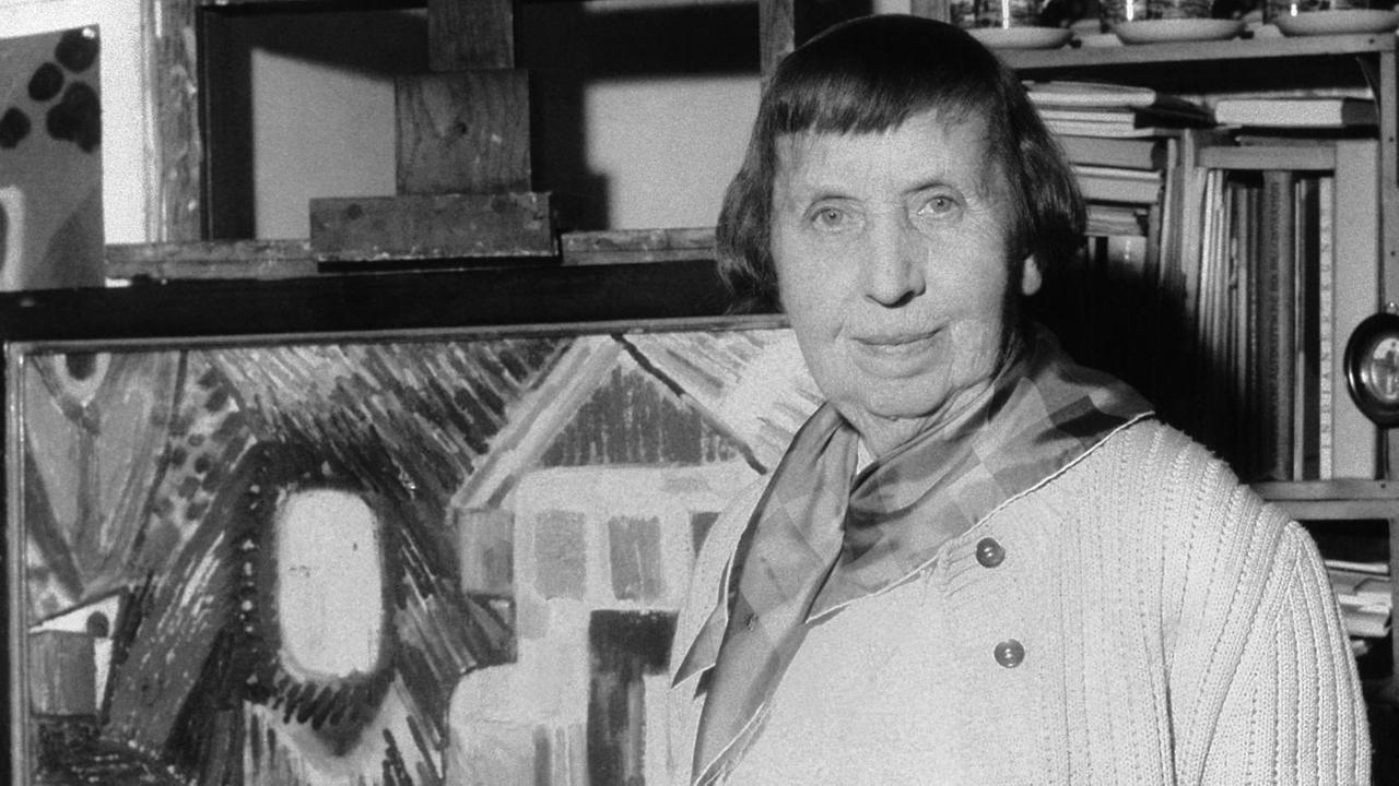 Die Malerin Ida Kerkovius 1959 in ihrem Stuttgarter Atelier vor der Staffelei. Neben Gemälden gehören zahlreiche Wandteppiche zu ihrem Werk. Ida Kerkovius wurde am 31. August 1879 (russischer Kalender) in Riga geboren und verstarb am 7. Juni 1970 in Stuttgart.
