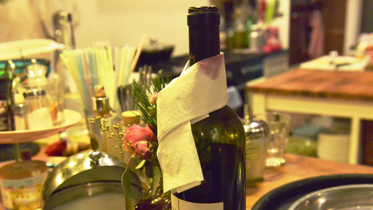 In einer Küche steht eine Flasche Wein.