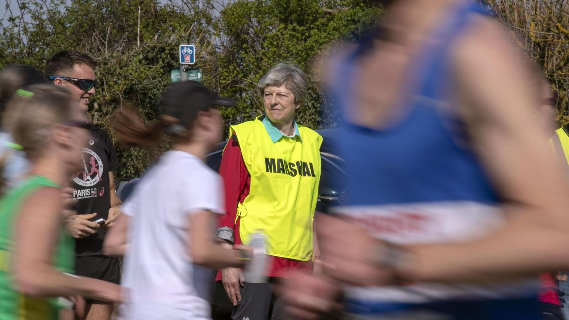 Theresa May at the Maidenhead Easter 10. Prime Minister Theresa May acts as a marshal during the Maidenhead Easter 10 race in maidenhead. Picture date: Friday April 19, 2019. Photo credit should read: Steve Parsons/PA Wire URN:42407796 |