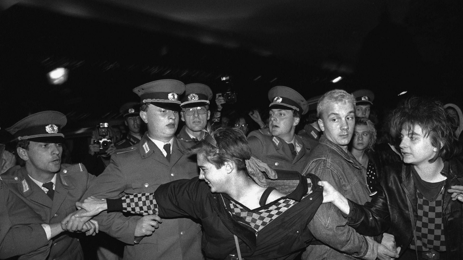 Eine Frau versucht, eine Demonstrantin von der Polizeikette weg zu ziehen. Am 7. Oktober 1989 kam es wie in anderen ostdeutschen Städten auch in Ostberlin zu Demonstrationen gegen die Machthaber in der DDR.