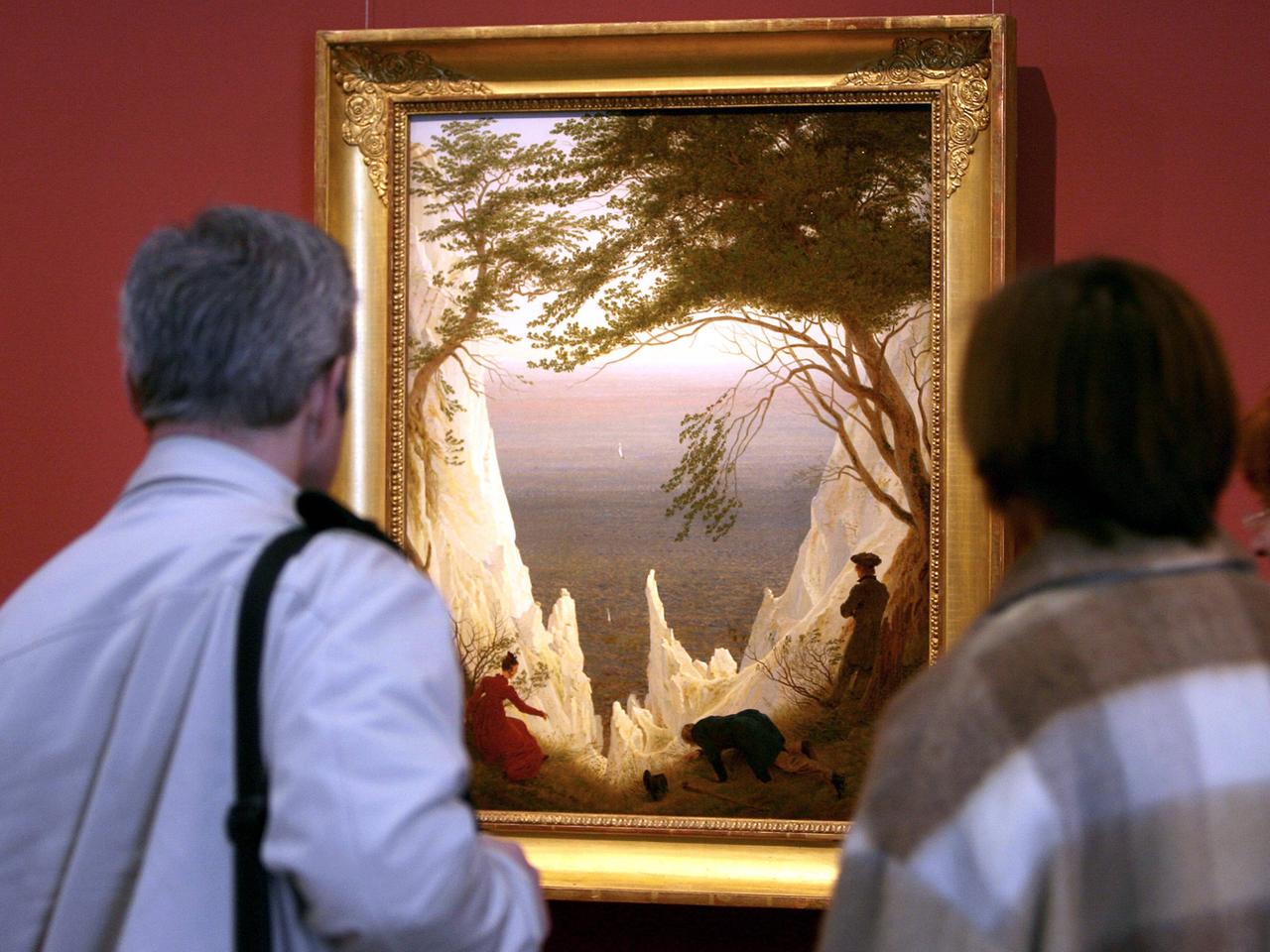 Besucher betrachten das Gemälde "Kreidefelsen auf Rügen" von Caspar David Friedrich während der Ausstellung "Die Erfindung der Romantik" im Museum Folkwang in Essen.