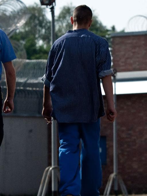 Zwei Gefangene gehen am 18.09.2012 in Betreuung eines Justizangestellten über das Gelände der Untersuchungs- und Jugendhaftanstalt Berlin-Tegel.