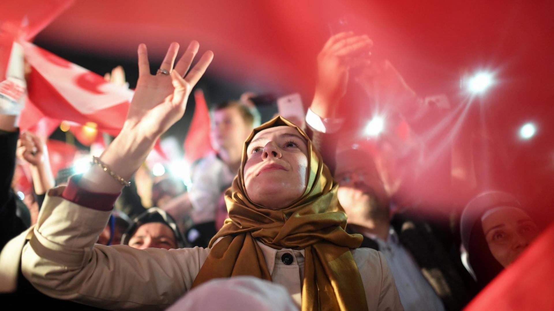 Eine Anhängerin des türkischen Staatschefs Erdogan zeigt das sogenannte Rabia-Zeichen.