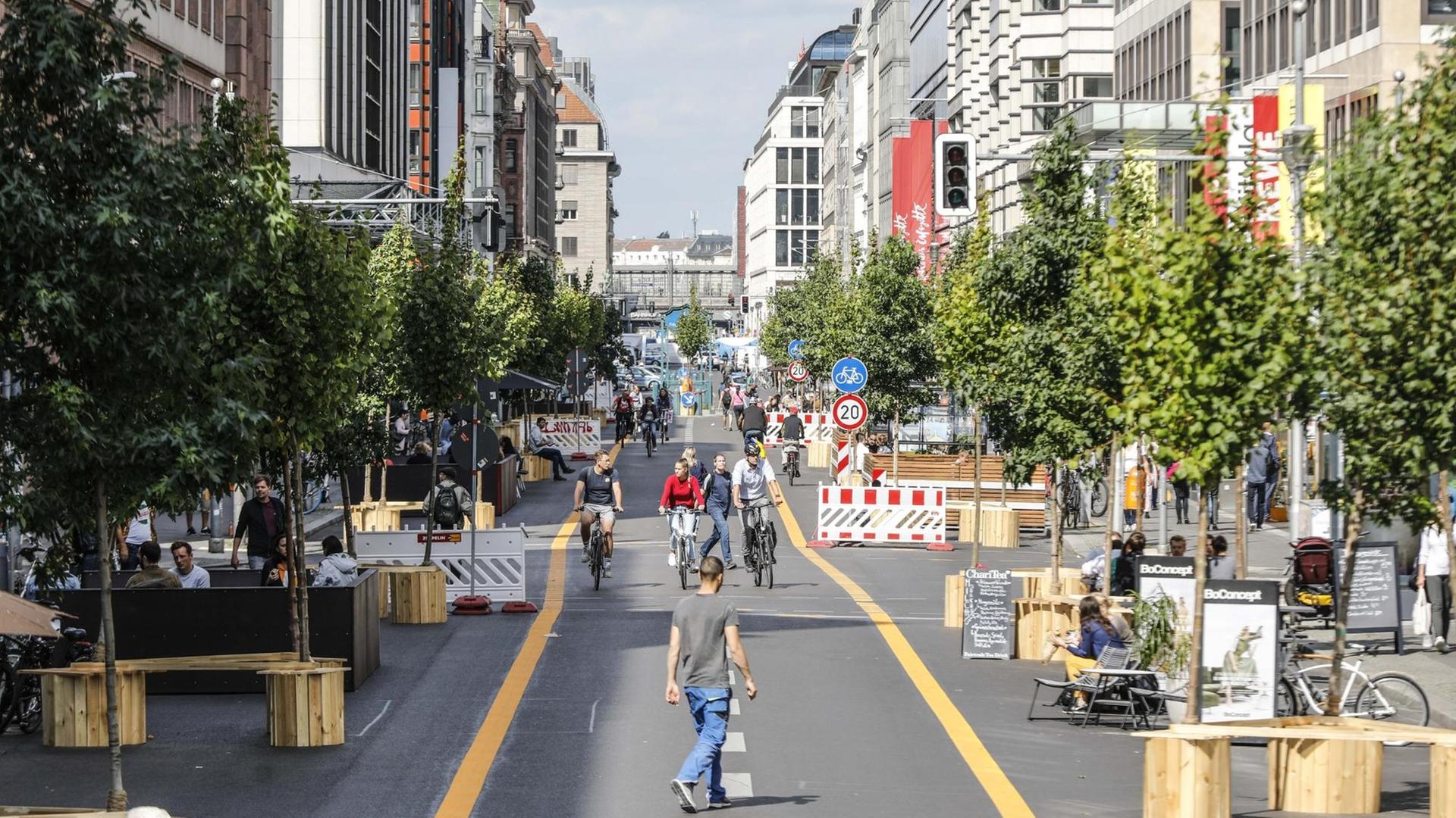Radfahrer, Rollerfahrer und Fußgänger sind auf der autofreien Berliner Friedrichstrasse unterwegs. Auf einem 500 Meter langen Abschnitt ist der Verkehr für Autos bis Ende Januar 2021 gesperrt.