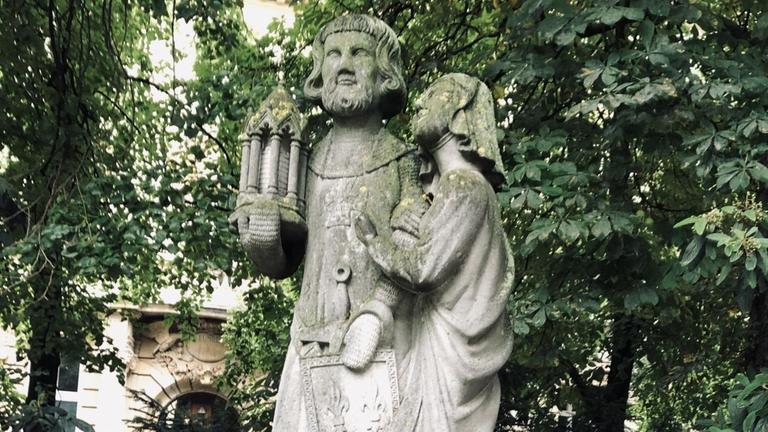 Der französische König Ludwig IX. und seine Gattin Margarete: in Stein gehauene Figuren, in den Gesichtern und auf den Schultern mit Moos überwachsen