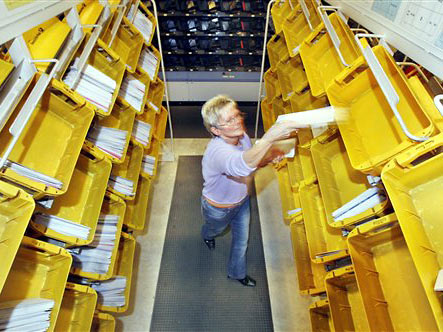 Eine Mitarbeiterin der Deutschen Post sortiert Briefe im Briefzentrum im Güterverkehrszentrum in Erfurt.