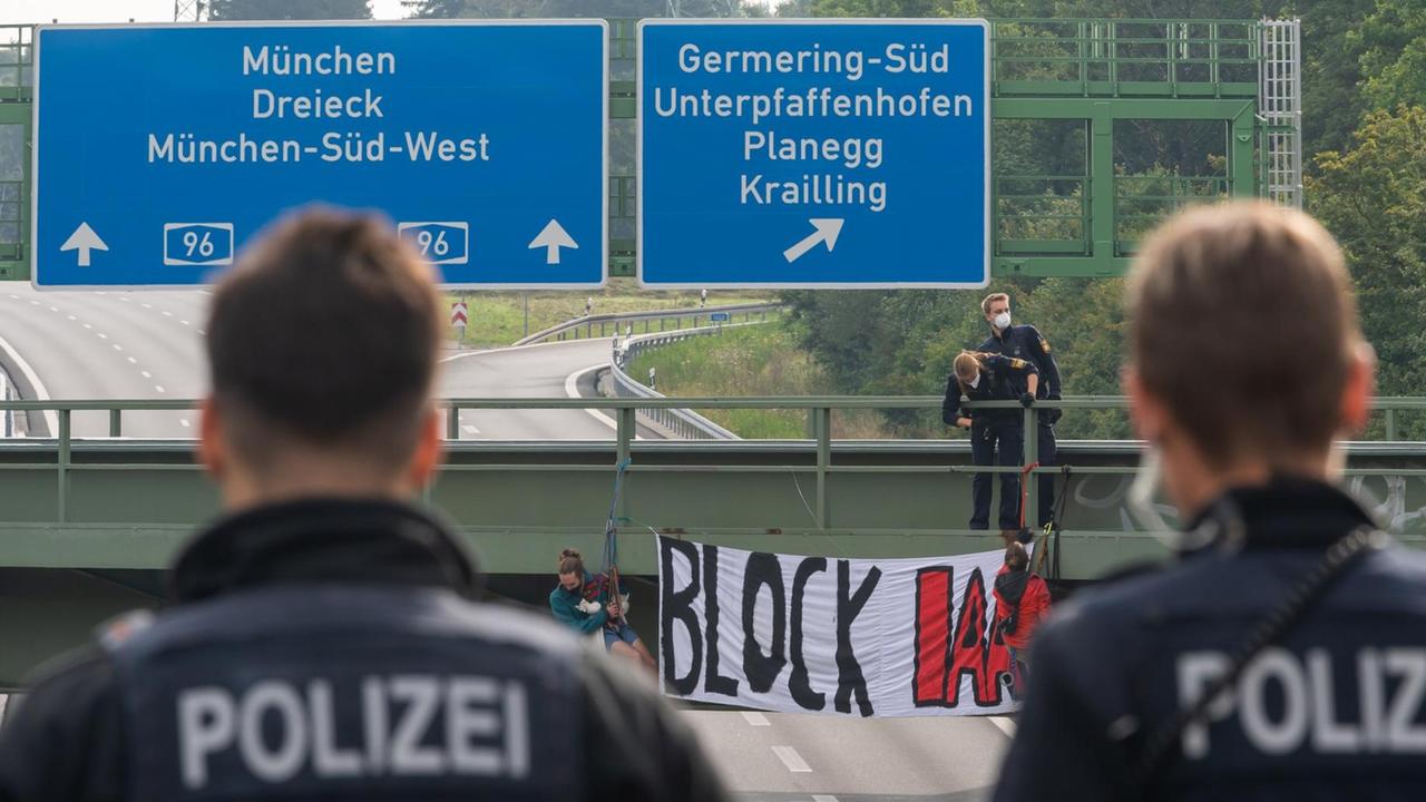 Aktivisten seilen sich an einer Brücke über der Autobahn A96 bei Germering ab. Auf dem Banner steht „Block IAA“. Die Autobahn wurde Richtung München gesperrt. Polizei und Feuerwehr sicherten die betreffende Stelle.