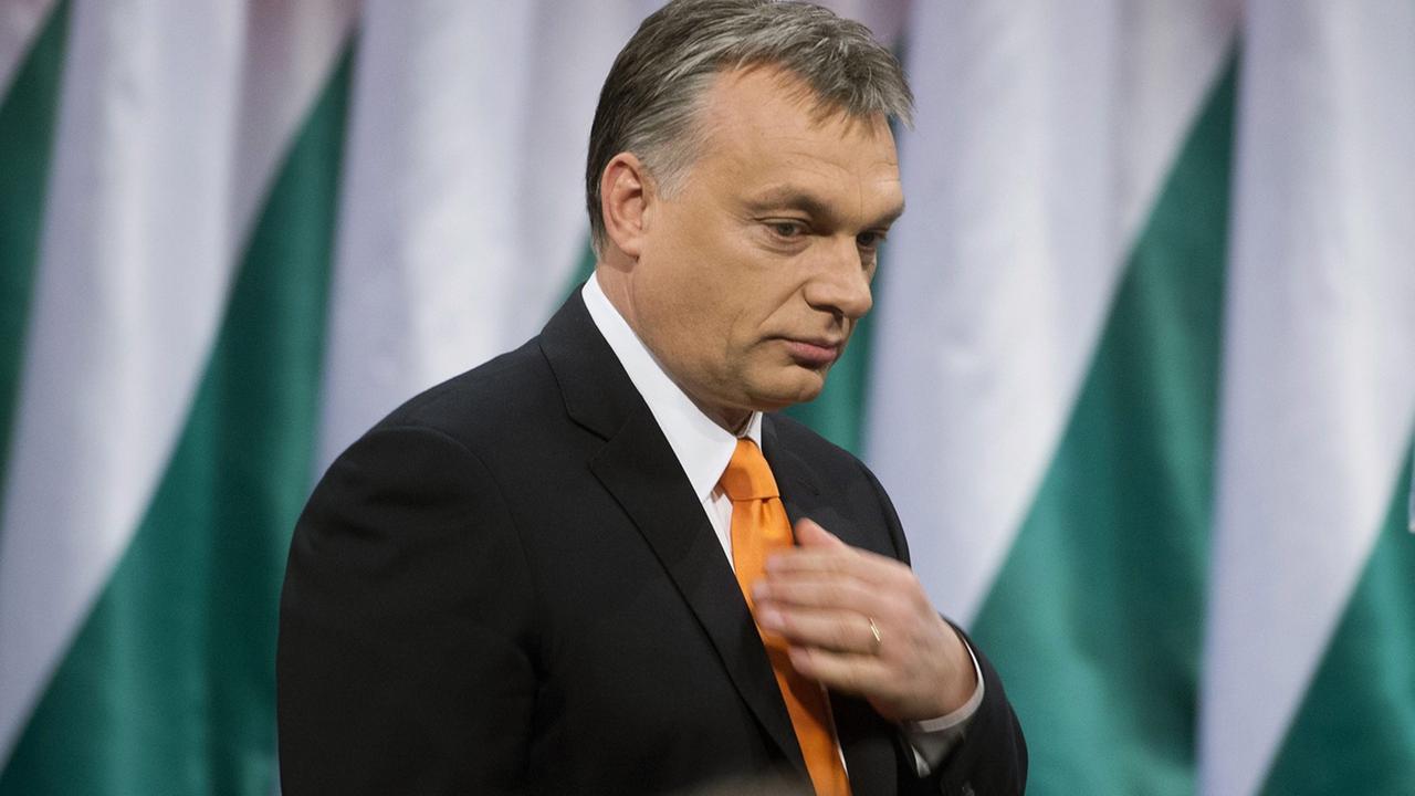 Präsident Viktor Orban steht vor ungarischen Landesflaggen.