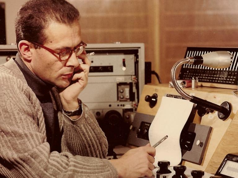 Herbert Brün mit Zigarette und Notizen am Pult im Elektronischen Studio
