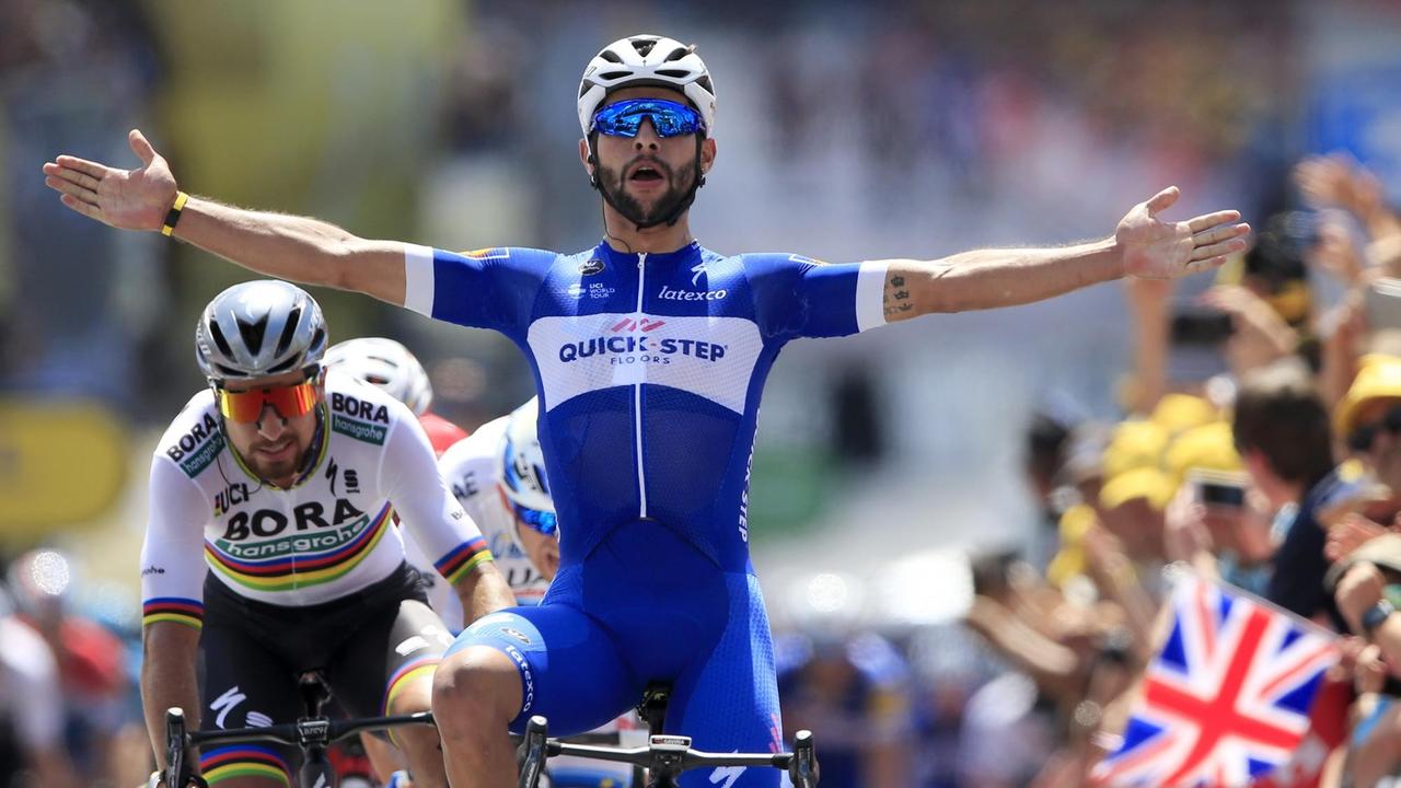 Colombia's Fernando Gaviria crosses the finish line ahead of Peter Sagan of Slovakia, left, to win the first stage of the Tour de France cycling race over 201 kilometers (124.9 miles) with start in Noirmoutier-en-L'Ile and finish in Fontenay Le-Comte, France, Saturday, July 7, 2018. (AP Photo/Peter Dejong)