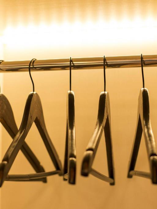 Ein Kleiderstange behangen mit leeren Bügeln.