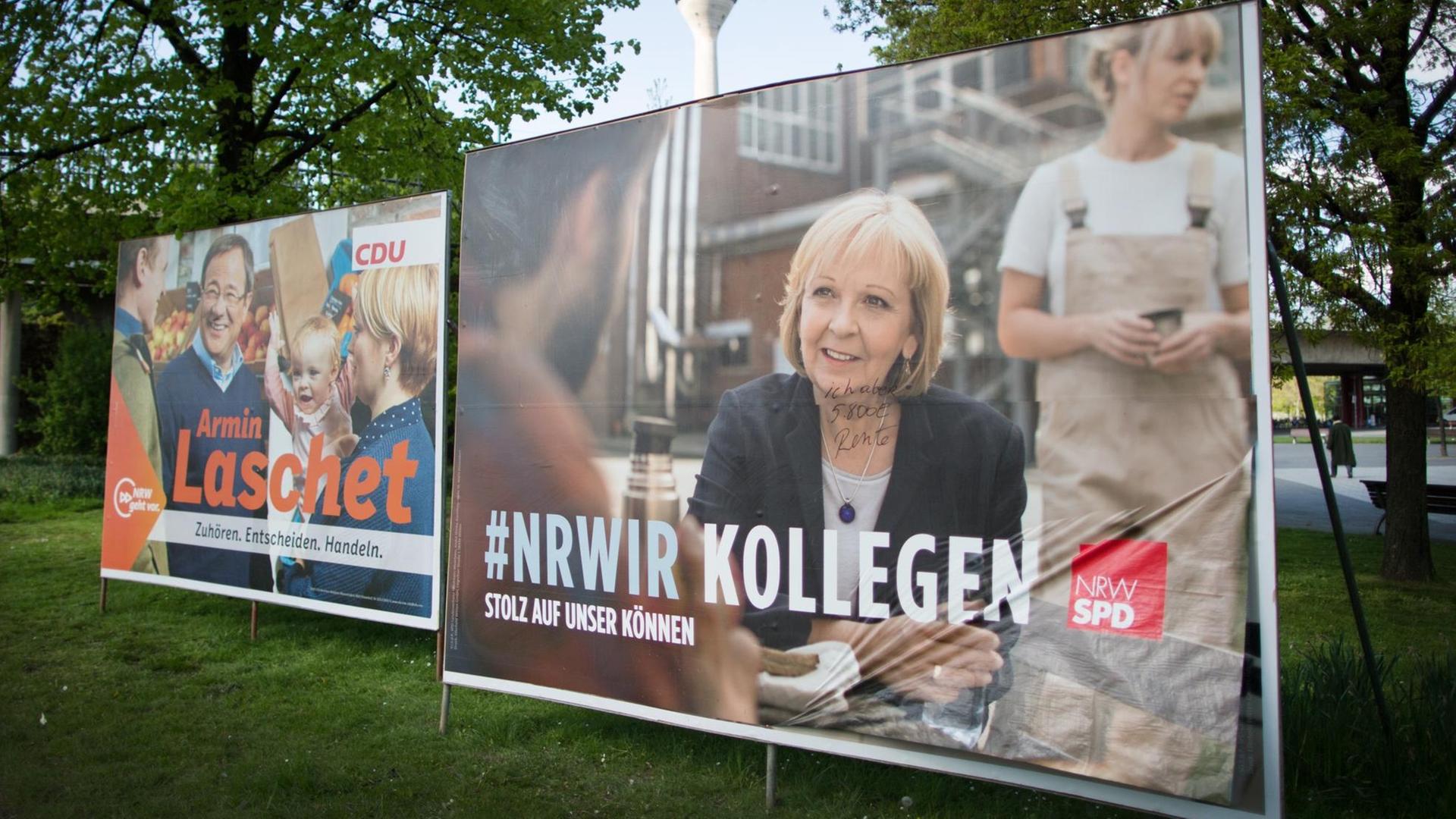Wahlplakate der nordrhein-westfälischen Spitzenkandidaten in Düsseldorf. Links ein Plakat der CDU mit Laschet und rechts eines der SPD mit Kraft.