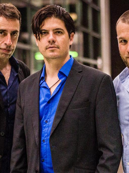 Die drei Musiker des Trios "Pablo Woiz & Milonga Roots" stehen zusammen und blicken in die Kamera