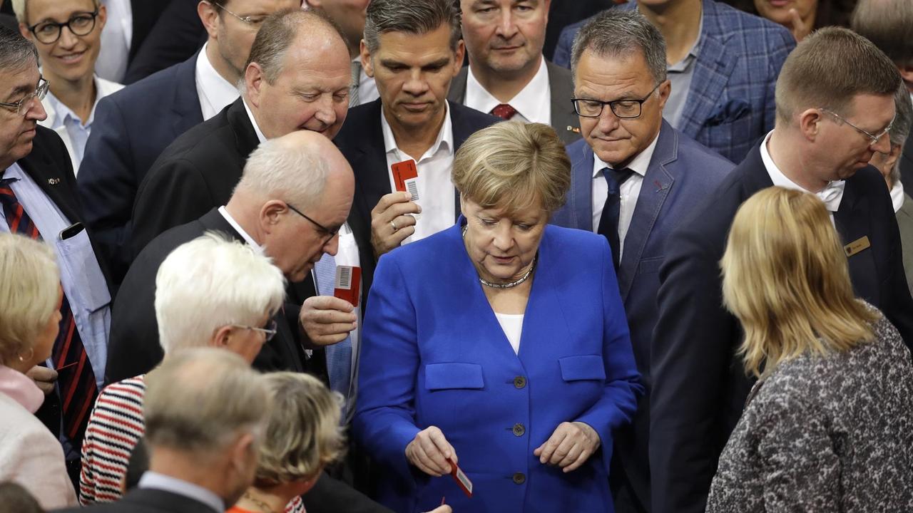 German Chancellor Angela Merkel casts her vote during a meeting of the German Federal Parliament, Bundestag, at the Reichstag building on the ballot of the marriage for everybody in Berlin, Germany, Friday, June 30, 2017. (AP Photo/Michael Sohn)