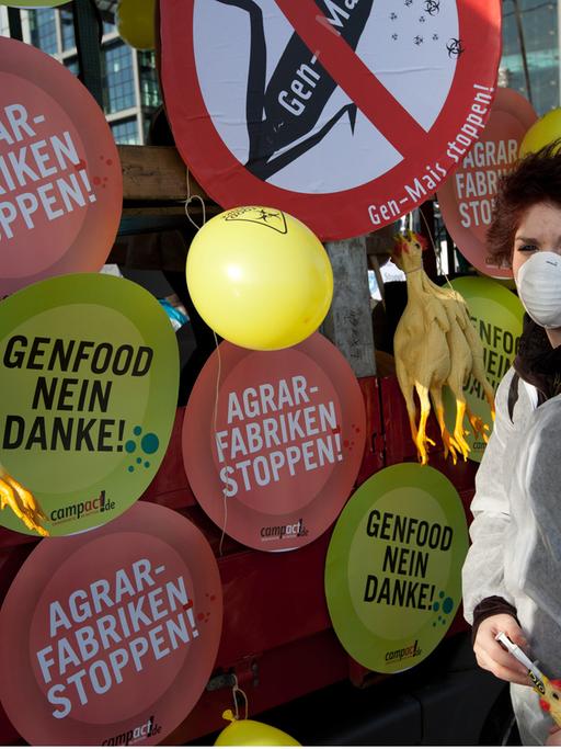 Eine maskierte Demonstrantin protestiert gegen Gen-Food in Berlin.