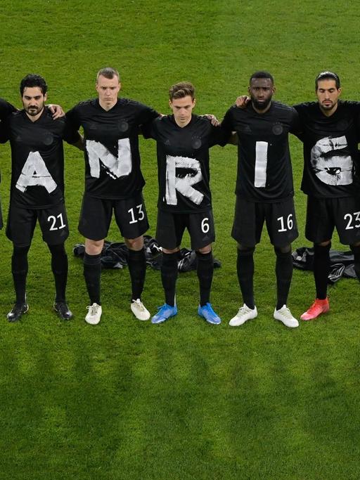 Deutsche Fußball-Nationalelf mit Buchstaben auf Trikots, die zusammen "Human Rights" ergeben