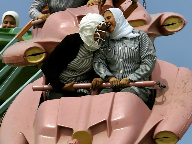 Palästina 2006: Junge Frauen genießen eine Achterbahnfahrt in einem Vergnügungspark in Gaza City.