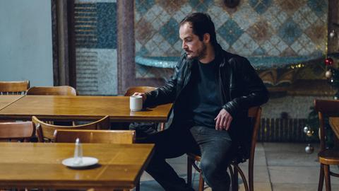 Max Czolleck, Autor von 'Desintegriert euch', sitzt im Dezember 2019 im Maxim Gorki Theater in Berlin und blickt nachdenklich auf seine Kaffeetasse.