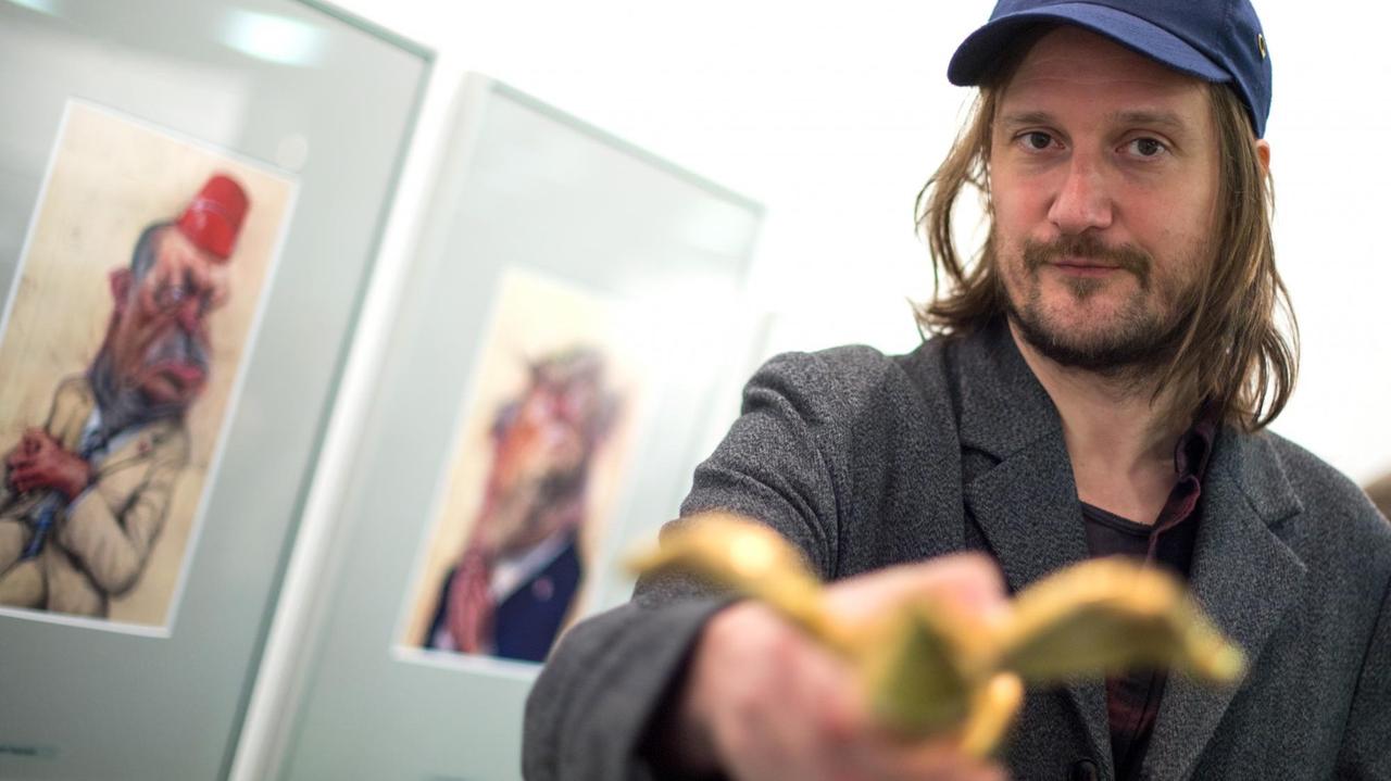 Frank Hoppmann, der Gewinner des Deutschen Karikaturenpreises 2017, mit dem "Geflügelten Bleistift in Gold".