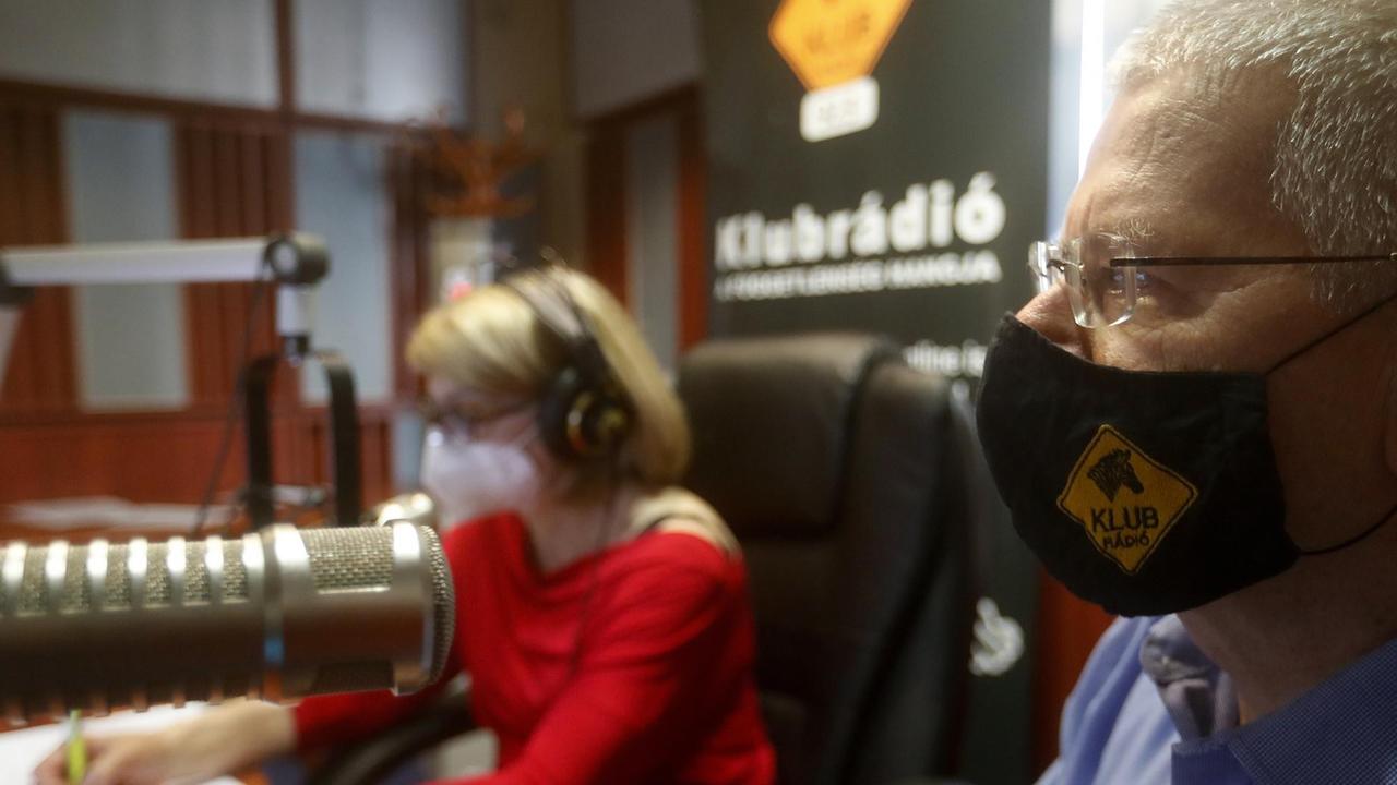 Eine Moderatorin und ein Moderator sitzen am Mikrofon im Studio des ungarischen Radiosenders "Klubradio"