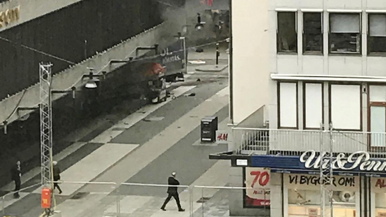 People look on at the scene after a truck crashed into a department store injuring several people in central Stockholm, Sweden, Friday April 7, 2017. (Andreas Schyman, TT News Agency via AP)