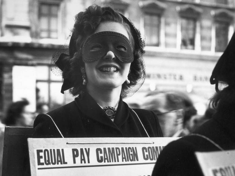 7th May 1952: Sonia Banular wears a mask to a poster parade in London demanding equal pay for women. (Photo by Keystone/Getty Images)