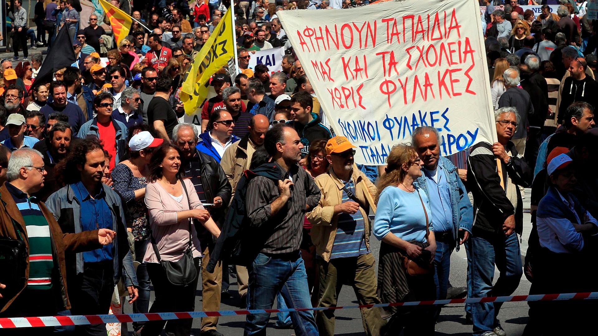 epa04160293 Protesters shout slogans during a general strike outside of the Greek Parliament in Athens, Greece, 09 April 2014. Greece's two largest public and private sector unions began a 24-hour nationwide walkout to protest against austerity measures t