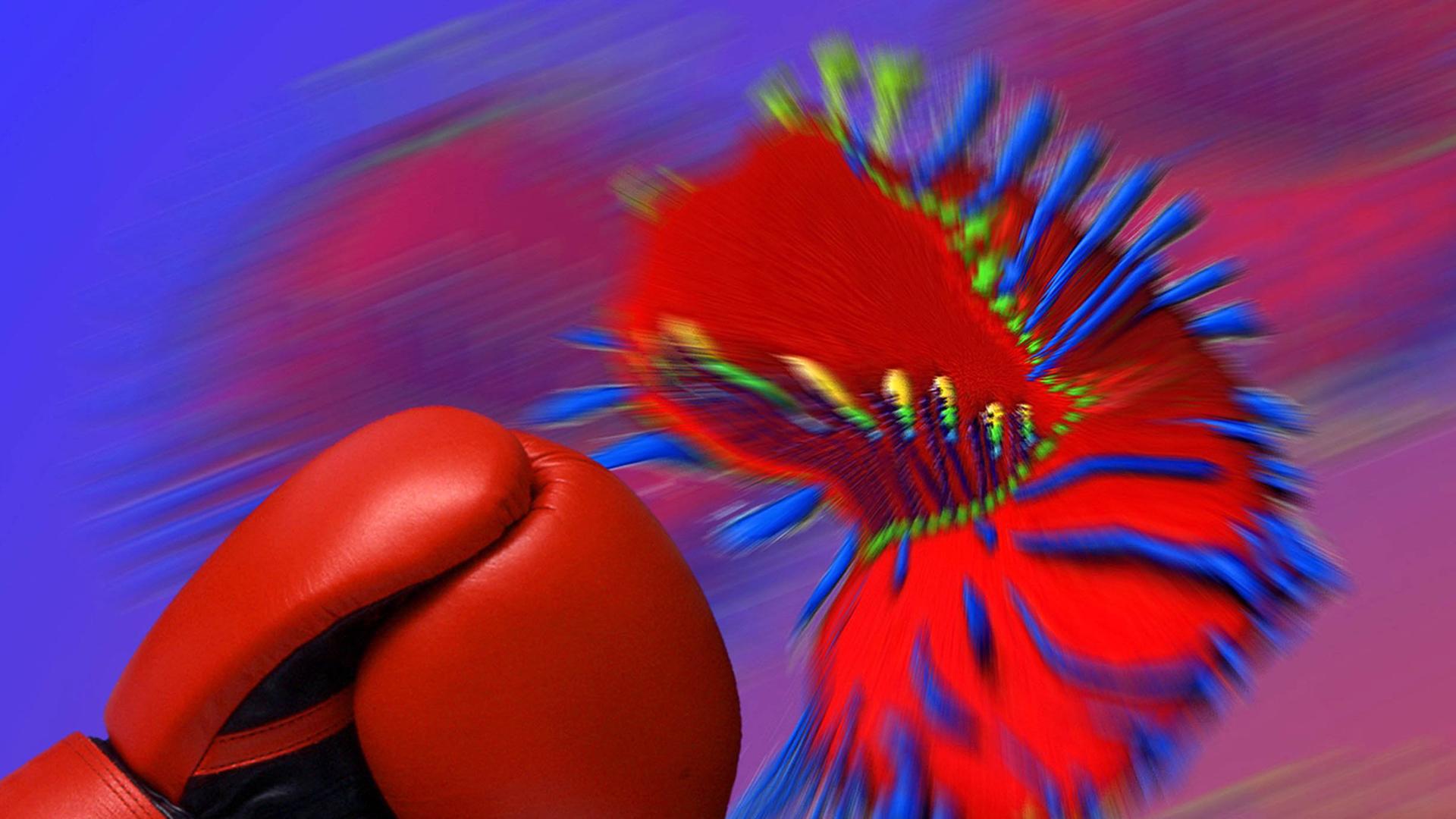Ein Boxhandschuh wehrt den Angriff eines Virus ab.