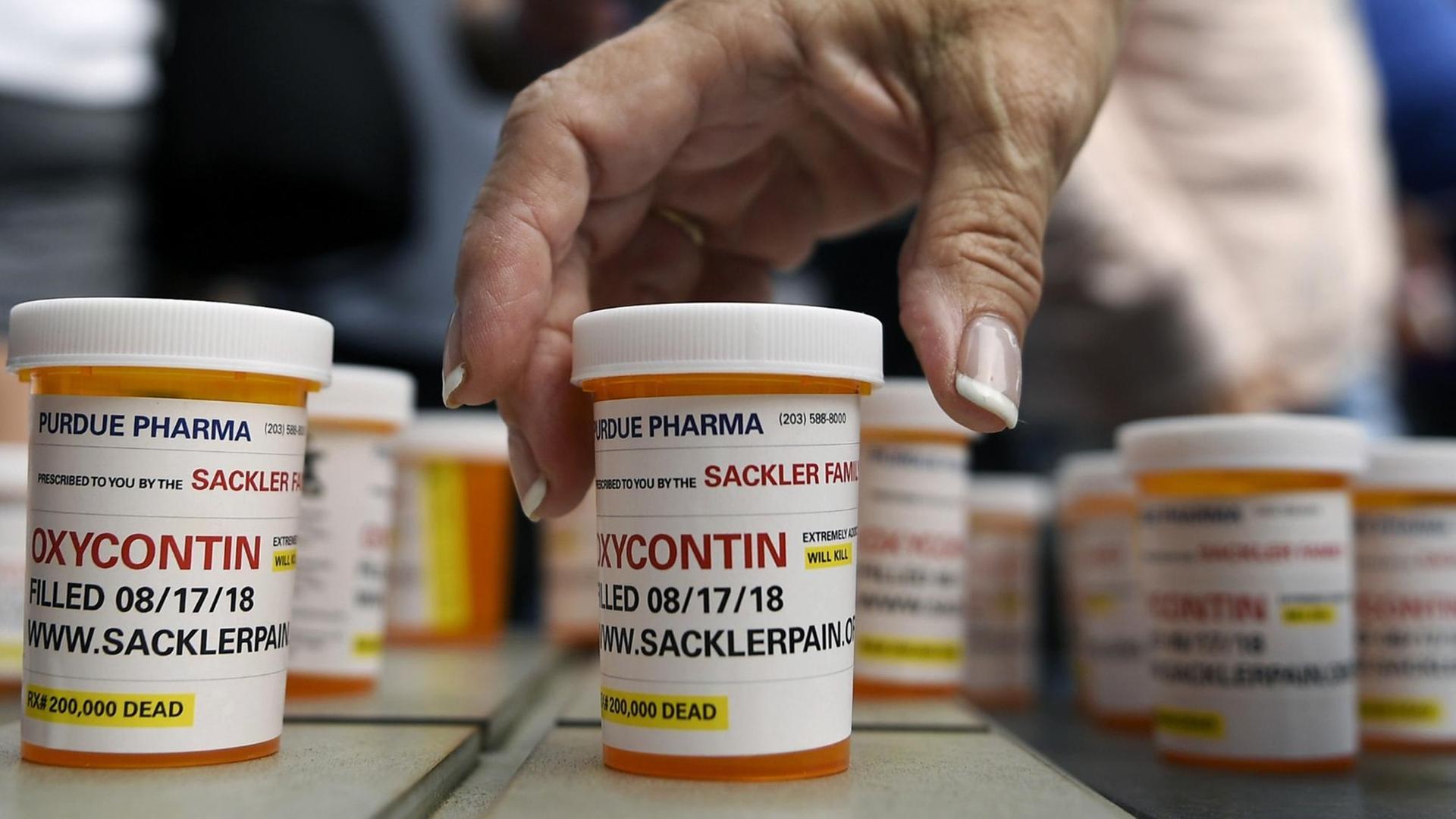 FILE - In this Aug. 17, 2018 file photo, family and friends who have lost loved ones to OxyContin and opioid overdoses leave pill bottles in protest outside the headquarters of Purdue Pharma, which is owned by the Sackler family, in Stamford, Conn. New York is suing the billionaire family behind Oxycontin, alleging the drugmaker fueled the opioid crisis by putting hunger for profits over patient safety. (AP Photo/Jessica Hill, File) |