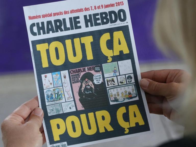 Eine Frau hält eine Ausgabe des Satiremagazin "Charlie Hebdo" mit den umstrittenen Mohammed-Karikaturen.