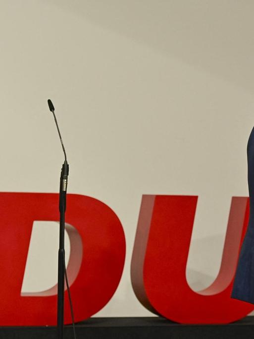 Armin Laschet verlässt eine CDU Bühne mit leerem Mikrofon.