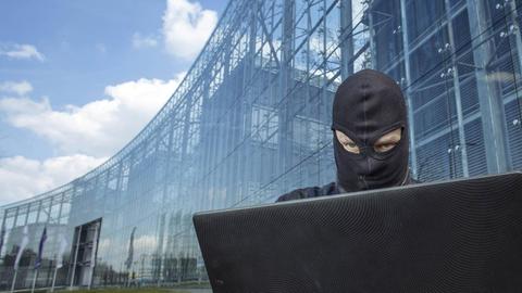 Ein Hacker vor dem Neven DuMont Haus in Köln.