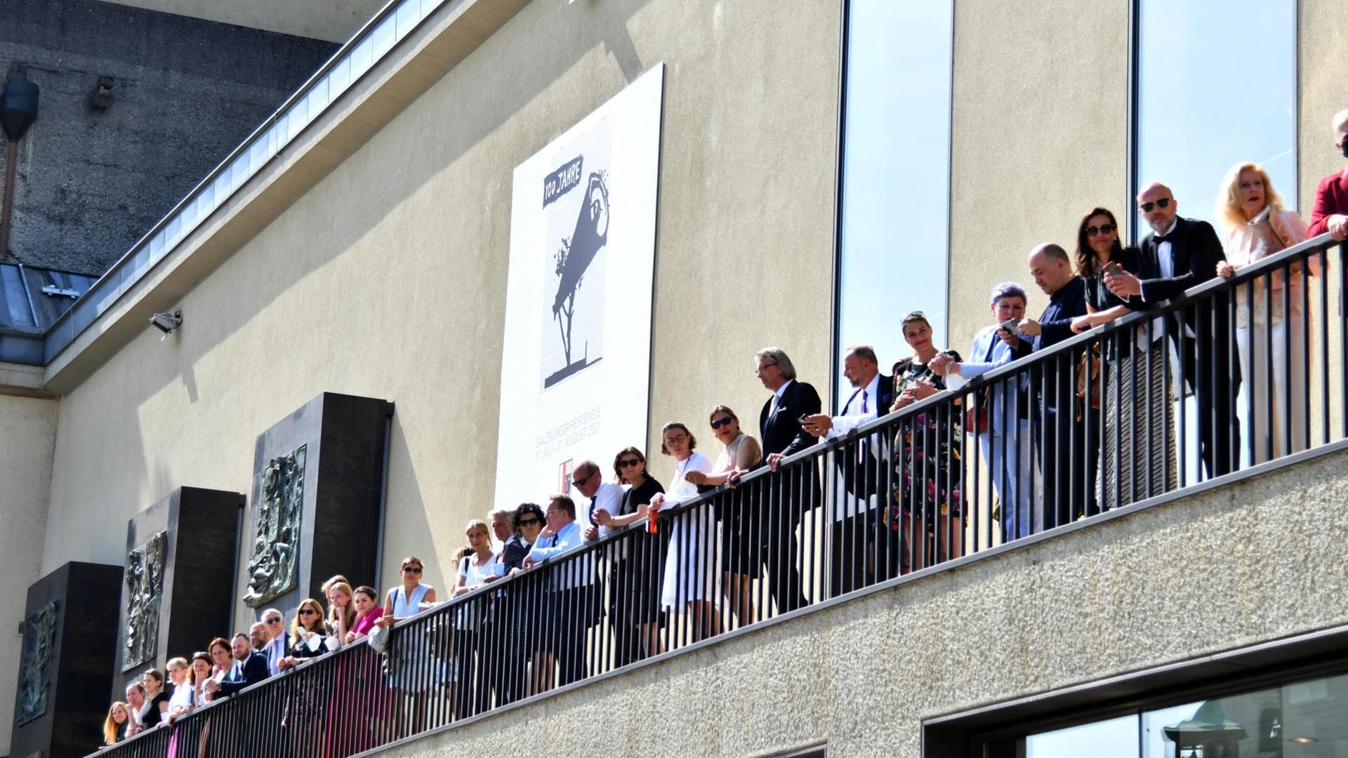 Festspielgäste warten auf einem Balkon auf die Eröffnung der Salzburger Festspiele.