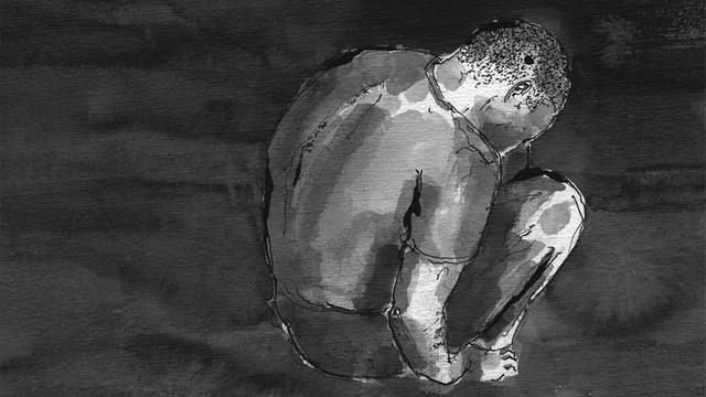 Ein Kauernder Jugendlicher in einer Gefängniszelle