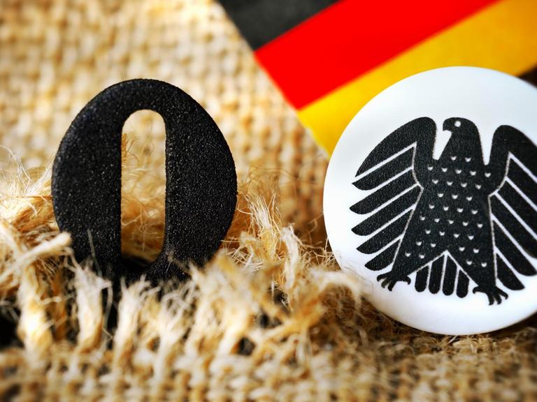 Die schwarze Null guckt aus einem aufgerissenen Geldsack heraus.