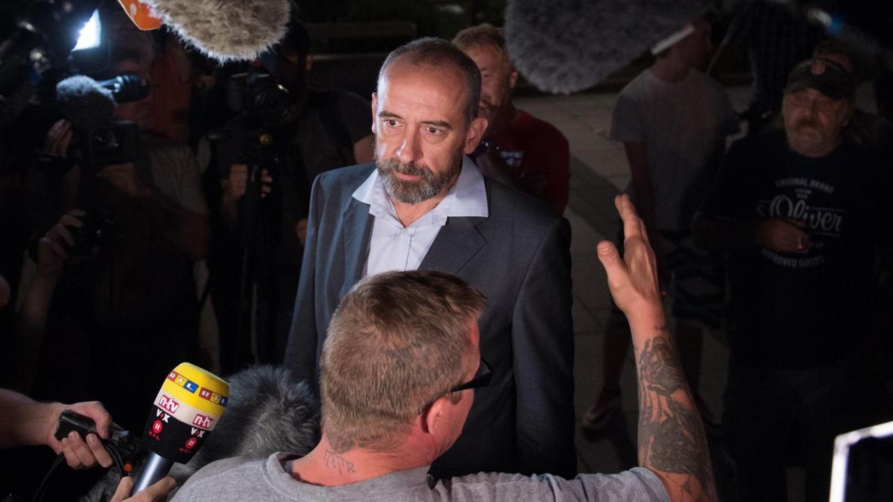 Bautzens parteiloser Oberbürgermeister Alexander Ahrens spricht mit einem Bürger, ringsum halten Journalisten Mikrofone ins Bild