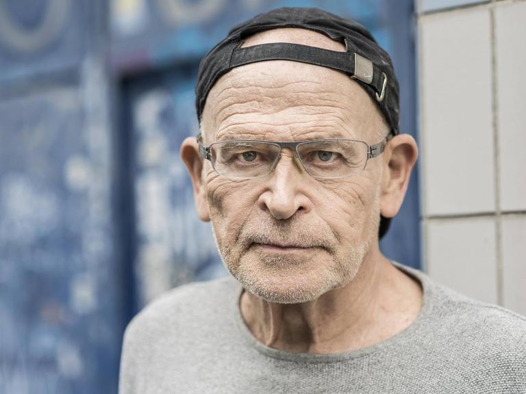 Ein älterer Mann mit Brille und Basecap.