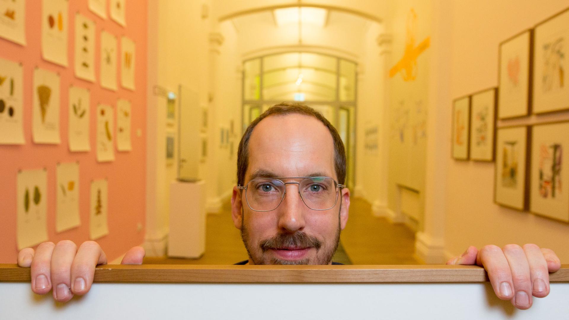Der Zeichner und Illustrator Christoph Niemann hält am 19.01.2016 in Hamburg im Museum für Kunst und Gewerbe (MKG) eines seiner Aquarelle in den Händen. Niemanns Ausstellung "Unterm Strich" ist vom 20. Januar bis zum 10. April 2016 zu sehen.