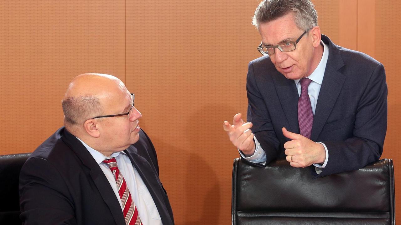 De Maiziere und Altmaier unterhalten sich während einer Kabinettssitzung im Kanzleramt