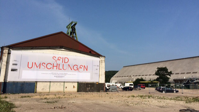 "Seid umschlungen", das Motto der Ruhrtriennale, hängt an einer alten Kohlemischhalle auf dem Gelände der Zeche Lohberg.