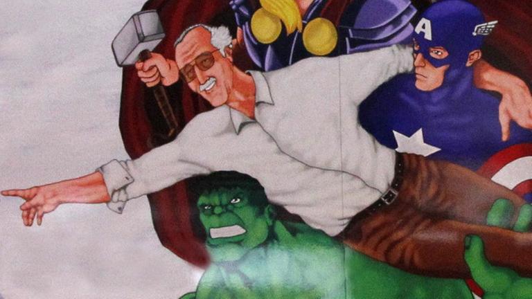 Eine Zeichnung von dem Comic-Autor Stan Lee zwischen seinen Superhelden Hulk, Capain America und Thor.