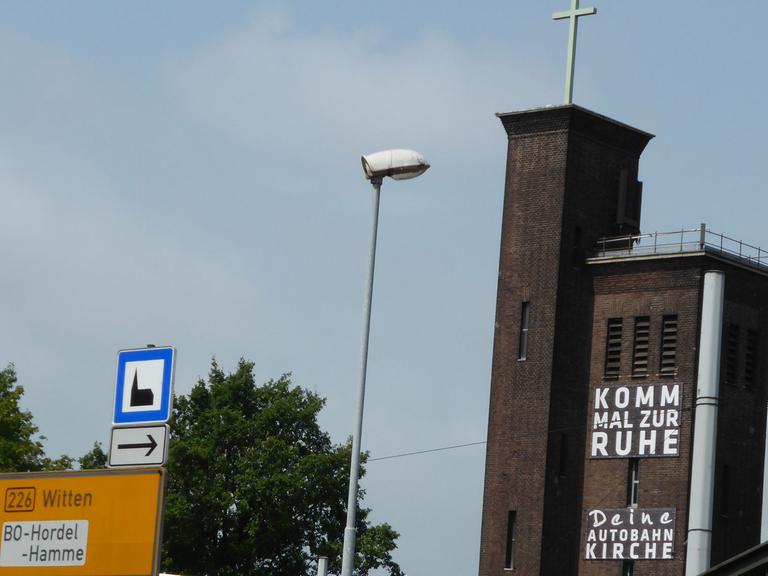 Die Autobahnkirche in Bochum an der A40 mit der Aufschrift "Komm mal zur Ruhe" und "Deine Autobahnkirche".