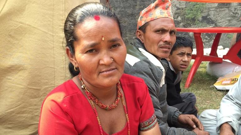 Sie sehen die Nepalesin Khali Tamang. Sie trägt ein rotes Oberteil und hat einen roten Punkt auf der Stirn.