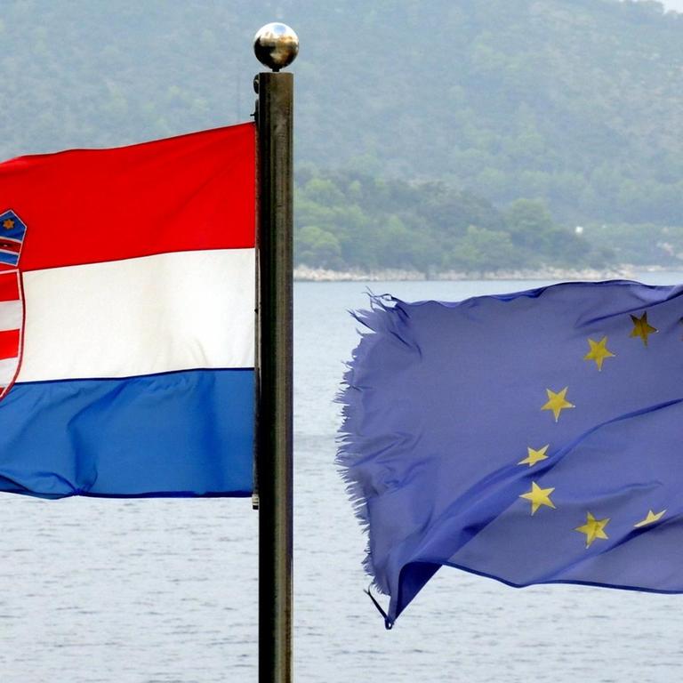Die Flaggen der Europäischen Union (r.) und von Kroatien (l.) flattern im Wind